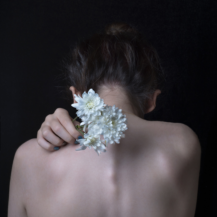 Pain management, pain relieve, photograph of woman's back with flowers by Hadis Safari