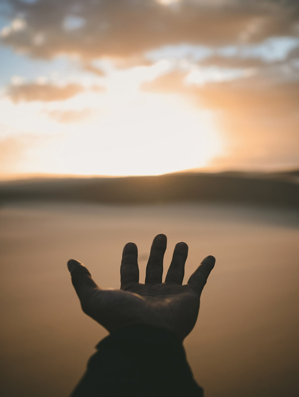 Sharing Your Light, Service to Others. Photograph of hand and sky by Billy Pasco