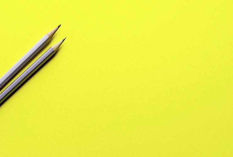 Blissing Out: A Writer’s Journey to Finding her Life Passion (and Tips for Finding Yours) by Diana Raab. Photograph of two pencils on a blank yellow canvas by Joanna Kosinka