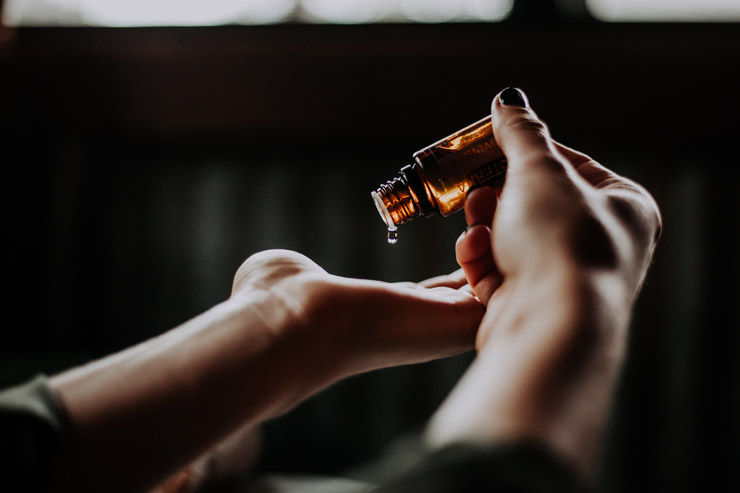 Non-traditional remedies, by Rachel O'Conner. Photograph of hands with vial by Christin Hume