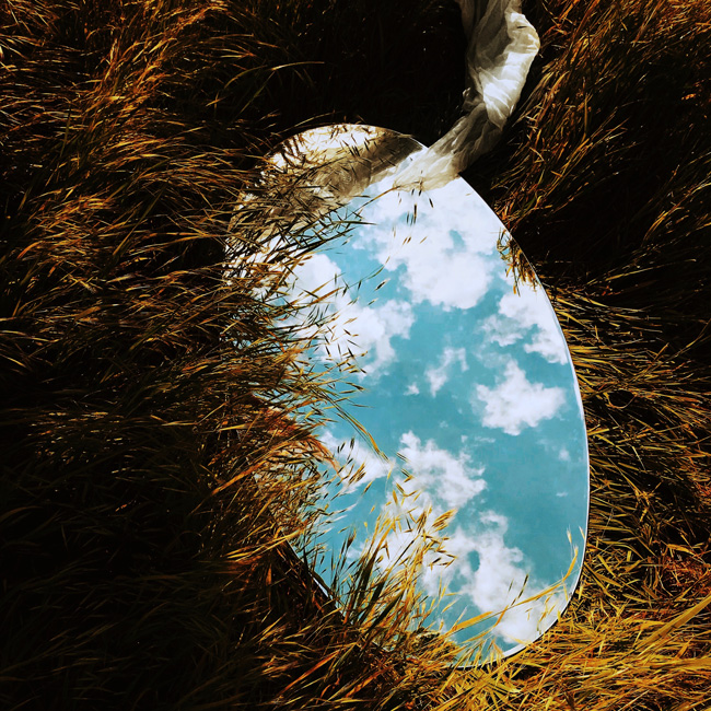 From self-destruction to self-love, by Jasmin Nelson. Photograph of mirror in grass by Inga Gezalian