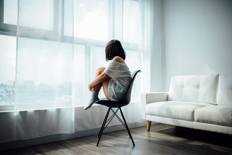 I Practiced Self Compassion for a Year — This is What Happened, by Rachelle McKeown. Photograph of woman sitting alone hugging herself, by Anthony Tran.