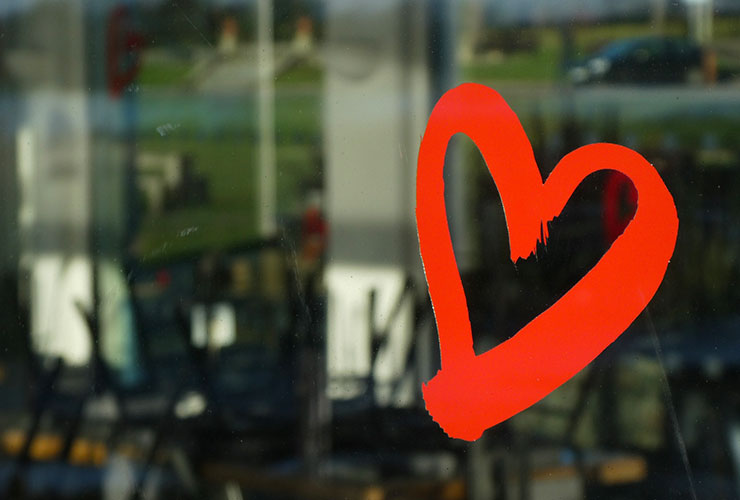 Healing A Broken Heart: The Scientific Benefits of Finding Your Frequency by Cara Hewett. Photograph of red painted heart on glass by Nick Fewings