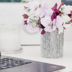 Love The Work You’re With: The ‘genius habit’ that will shift your relationship forever by Laura Garnett. Photograph of flowers at office desk by Georgia de Lotz