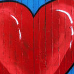 There is an undeniable selfishness to self-love… but nonetheless it is good, right and necessary to love yourself passionately by Scott Stabile. Photograph of heart pointed on a wall by Jon Tyson