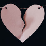 A Divorce Made in Heaven: The Gift of Conscious Un-Coupling by Sunny McMillan. Photograph of a broken paper heart on a string by Kelly Sikkema