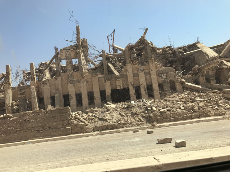 Photograph of a destroyed school building in Syria.