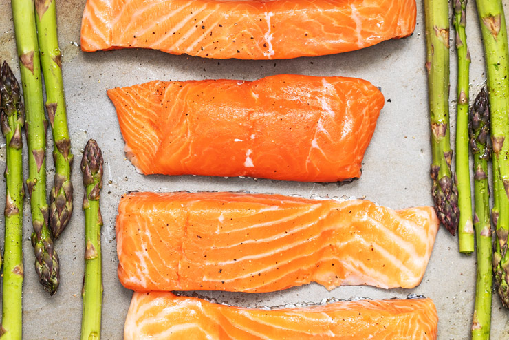 Photograph of raw salmon and asparagus on a cooking tray by Christine Siracusa