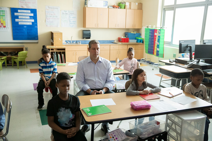 Meditating with students in a classroom; Congressman Ryan has been instrumental in introducing mindfulness into school systems. Photograph by Bill Miles