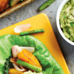 Spring Veggie Lettuce Wrap recipe by Dr. Will Cole. Photograph of Spring Veggie Lettuce Wrap with guacamole