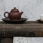 Inviting Your Demons to Tea: A Dance Between Self-Improvement & Self-Acceptance by Adreanna Limbach. Photograph of a tea pot on a wood bench by Oriento.