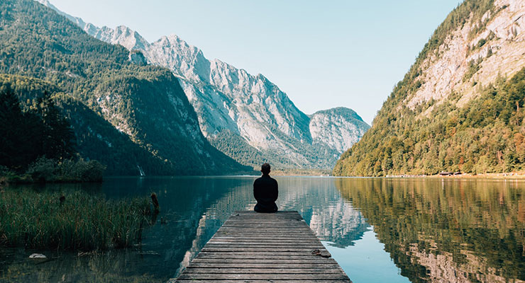 Mind Games: Exercising Your Mind for Emotional & Mental Health, by Annette Quarrier. Photograph of a man meditating in the mountains by Simon Migaj