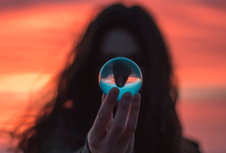 Clean Thoughts: 3 Principles of Information Hygiene for a Happy & Productive Life by Kristin Goad. Photograph of a woman looking into a crystal ball by Garidy Sanders