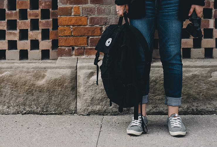 Avoiding College Burnout: 5 Sources of Academic Stress (and How to Deal with Them) by Rhonda Martinez. Photograph of a student with a backpack by Scott Webb