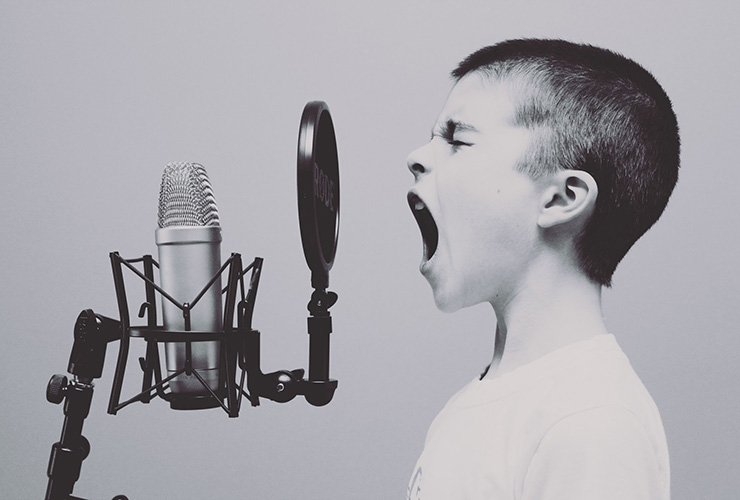 Building a Bridge Between Your Personal Voice and Your Spirituality by Scott Matthews. Photograph of a child yelling into a microphone by Jason Roswell