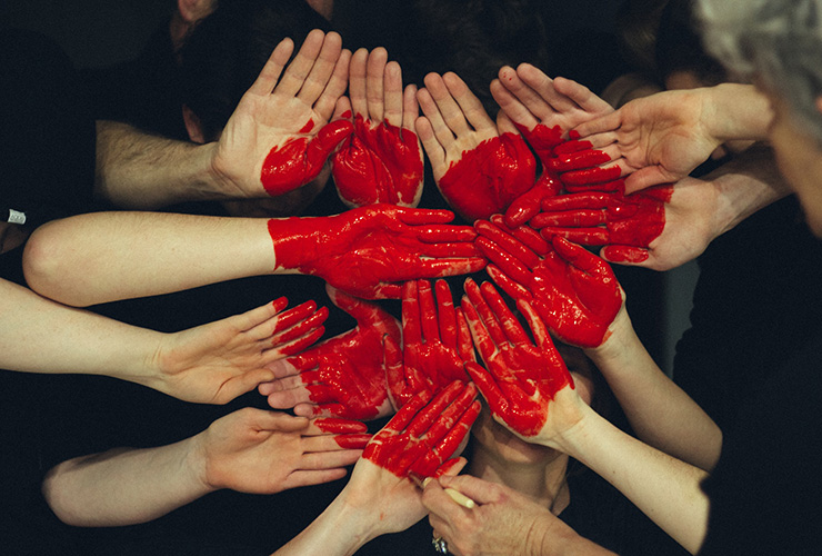 10 Longevity Tips All Women Need to Know for a Healthy Heart by Lynda Arbon. Photograph of a group of hands together with a heart painted on them by Tim Marshall