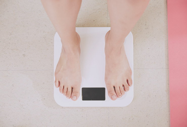 The Inner Game of Weight Loss: How to Shed Bad Habits and Unwanted Weight by Trevor McDonald. Photograph of feet on a weight scale by I-Yunmai