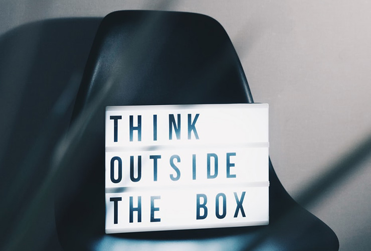 A Little Rebellion Goes a Long Way In Business (and Life) by Doris Schachenhofer. Photograph of a sign that reads "think outside the box" by Nikita Kachanovsky