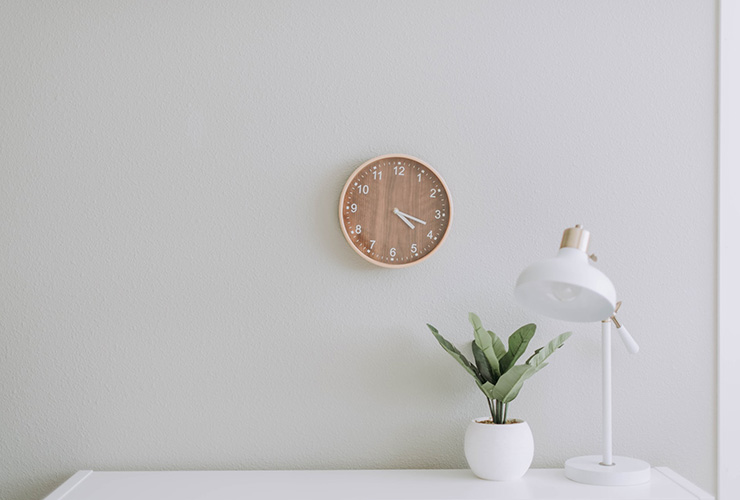 Time Management 101: 15 Tips for Increasing Productivity & Happiness by Frank Hamilton. Photograph of a wall clock hanging above a desk by Samantha Gades