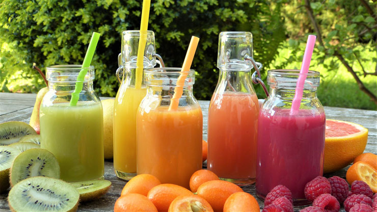 Juicing Basics: A Beginners Guide to Juicing by Julia Adams. Photograph of rainbow juices with different fruit by Sylvia Rita