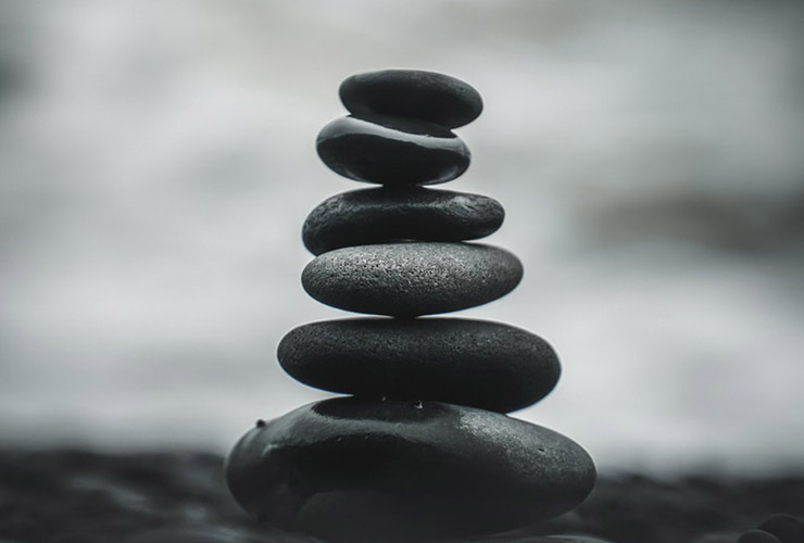 The Mechanics of Consciousness: How Transcendental Meditation Creates a State of Bliss by Barbara Ann Briggs. Photograph of rocks stacked up together Jeppe Hove Jensen