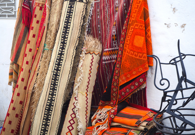 Photograph of rugs for sale at a Tangier bazaar, by Christine Moss