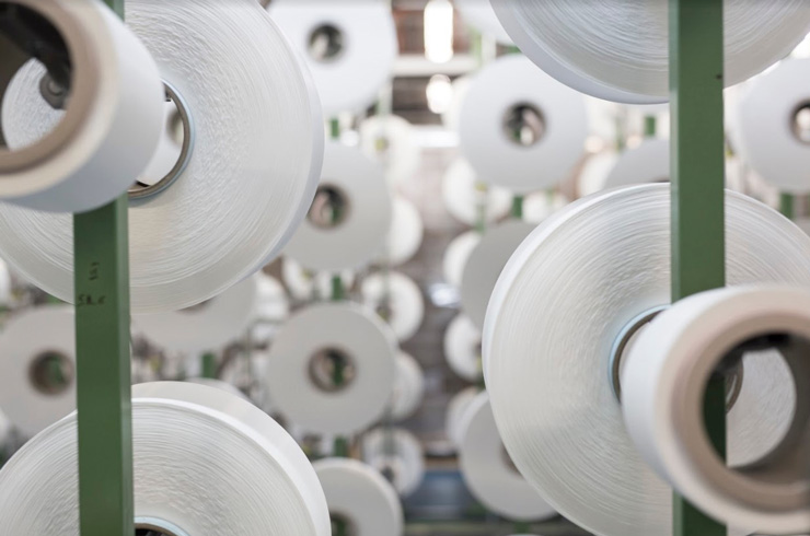 Photograph of spools of ECONYL® thread, created from recycled ocean waste