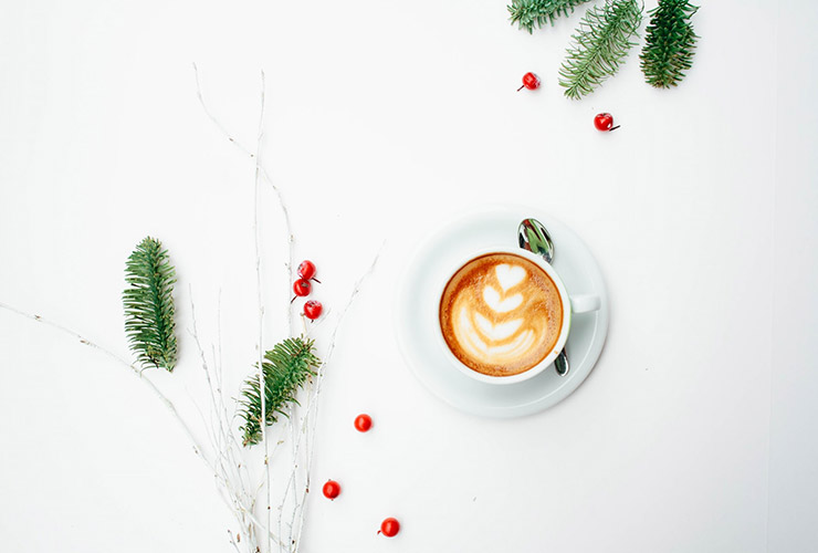 Tips for Emotional Self-Preservation During the Holidays: A Q&A with Dr. Dain Heer by Bill Miles. Photograph of a latte with Christmas decorations b Toa Heftiba.