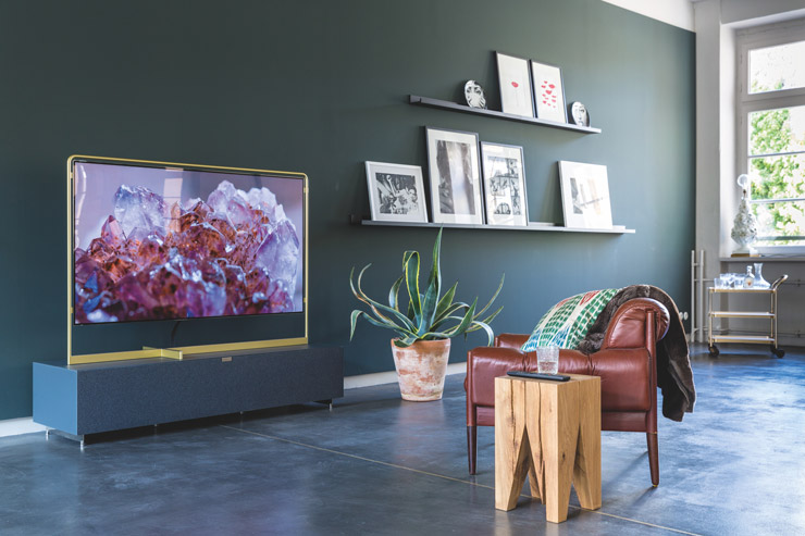 Photograph of a living room with lots of green, brown and gold colors