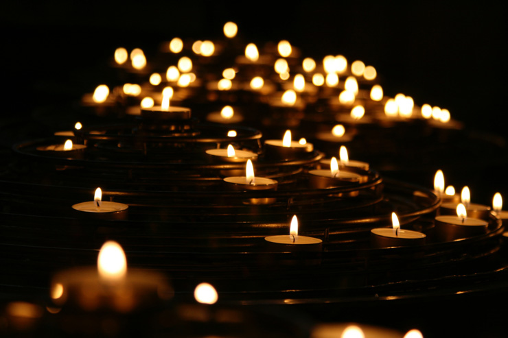 An Act of Faith: One Friend’s Loss is a Community’s Gain, by Jonah Sanderson.  Photograph of lit candles by Mike Labrum