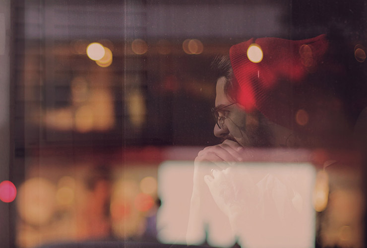 The Architecture of Thought: Mind Over Matter Is Real, but You Have to Believe it to See it by Samantha Glorioso. Photograph of a man thinking behind a window by Felipe Rizo