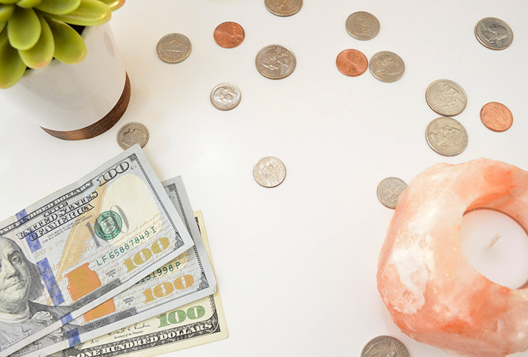 Money vs. Wealth: 5 Tenets for Creating True Prosperity by Moira Bramley. Photograph of money with a succulent and Himalayan salt lamp by Katie Harp.