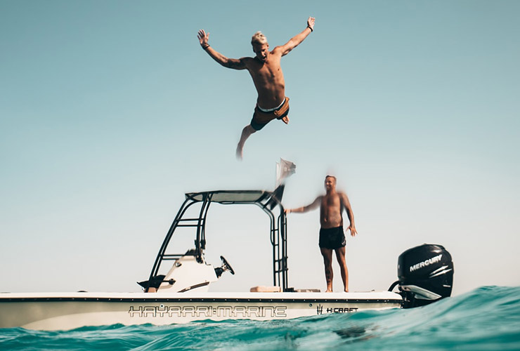Stop Comparing and Start Living: A Millennial’s Guide To A Meaningful Life by Rebecca Hulse. Photograph of a man jumping off of a boat by Oliver Sjostrom