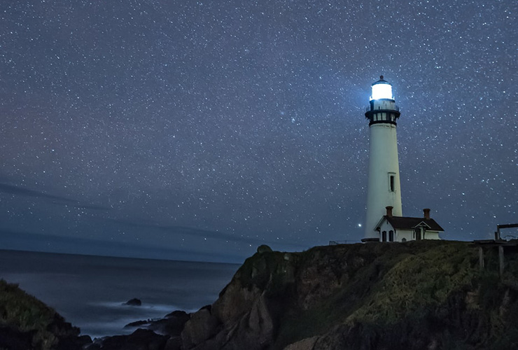 Finding Greater Meaning in Life Through Mindfulness, Stillness & Single Tasking by David Richards. Photograph of a lighthouse underneath the stars by Casey Horner