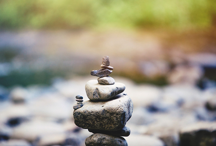 Body Balance: Simple Practices to Balance Your Metabolism for Better Health by Paisley Hansen. Photograph of stone balancing structure by Austin Neill