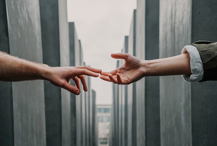 Emotional Intelligence: What Is It and Why Should You Care? by Shawn Mike. Photograph of two hands reaching out and touching by Toa Heftiba