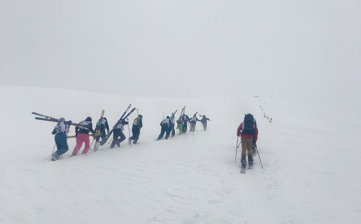 Stacy Bare and the competitors of the Uphill Competition of Afghan Ski Challenge; photograph of skiers treking uphill in the snow courtesy of Stacy Bare