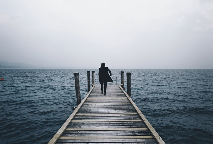 Finding Hope and Meaning at Life's End: One Doctor's Experience by Christopher Kerr. Photograph of a man walking towards the end of a dock by Alessio Lin