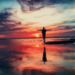 How to Take Control of Your Life and Begin Living Consciously by Damien Justus. Photograph of a man standing in the water during a sunset by Mohammed Nohassi