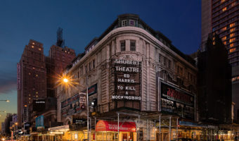 Bright Lights, Covid City: Broadway in the Dark By Dan Lane Williams. Photograph of a corner of broadway at night by Dan Lane WIlliams.