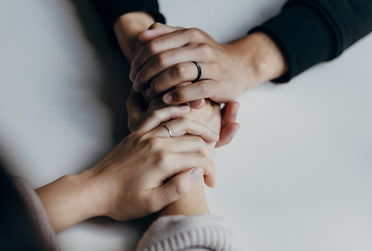 What Not to Say to Someone Living with Chronic Illness by Sweta Vikram. Photograph of two people holding hands by Priscilla Du Perez