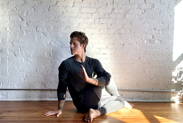 Yoga for Sciatica: Seven Poses to Relieve Lower Back Pain, by Brad Ormsby. Photograph of a man in a yoga twist by Carter Miles