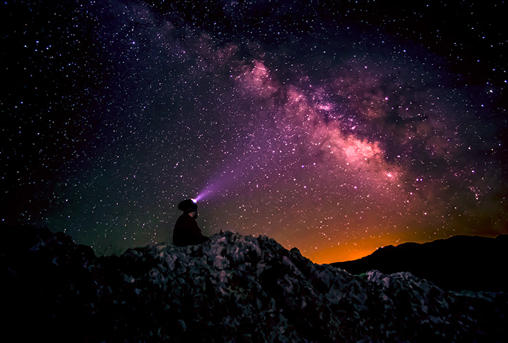 Inner Beauty Based on Your Enneagram Personality Type by Madison Smith. Photograph of a man at night looking up at the stars by Manouchehr Hejazi