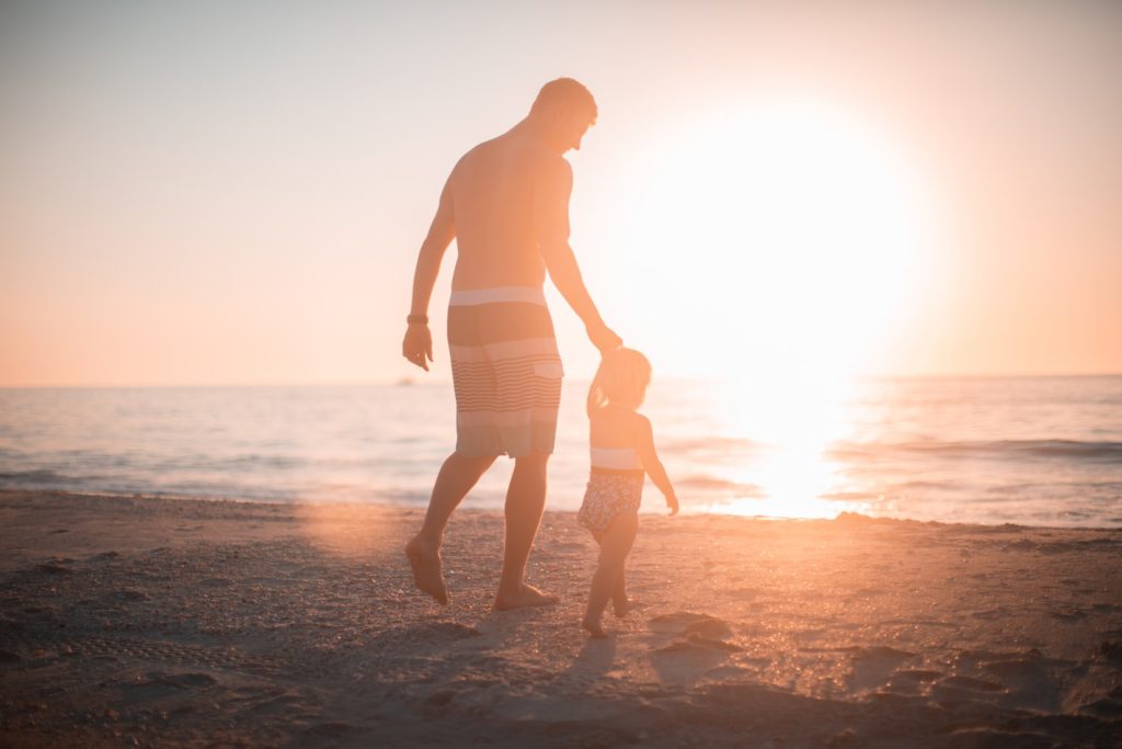 Photograph of a dad with his daughter at the beach