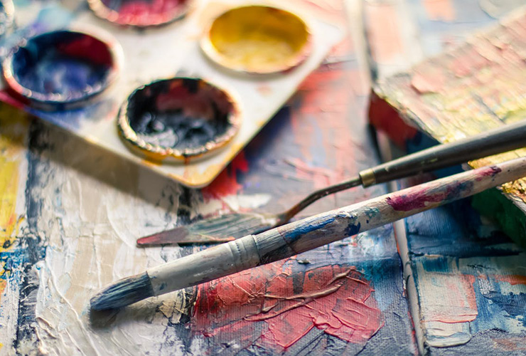 Discover Yourself By Trying New Things by Jori Hamilton. Photograph of messy paintbrushes on a canvas by Steven Johnson