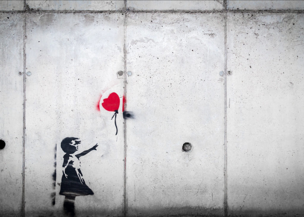 Loss, Love & Lessons: Finding Happiness Again After a Devasting Loss, by Dr. Solomon Stevens. Photograph of street art of a girl releasing a heart shaped balloon by Karim Manjra.