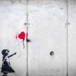 Loss, Love & Lessons: Finding Happiness Again After a Devasting Loss by Dr. Solomon Stevens. Photograph of street art of a girl releasing a heart shaped balloon by Karim Manjra.