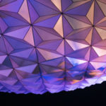 Emergence of a New World Order by Barbara Ann Briggs. Photograph of a colorfully lit, giant geometric planet sculpture by Katherine McAdoo
