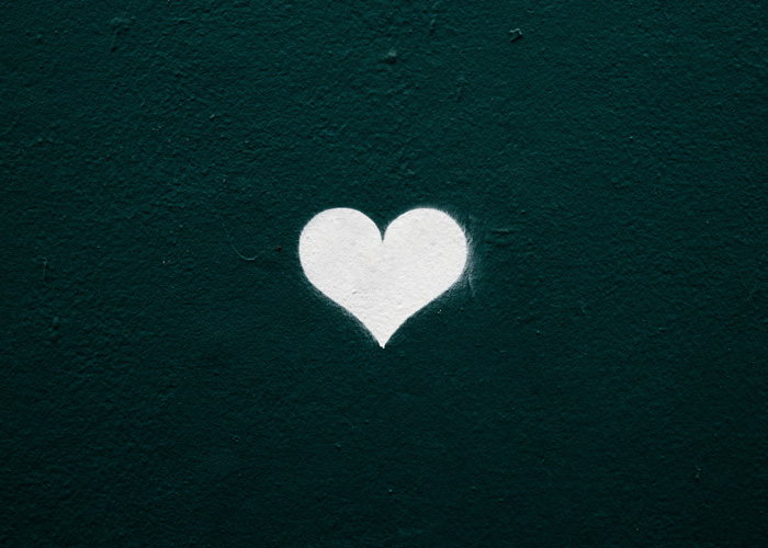 No Man Left Behind by Carter Miles. Photograph of a heart spray painted on a wall by Nicole Fioravanti