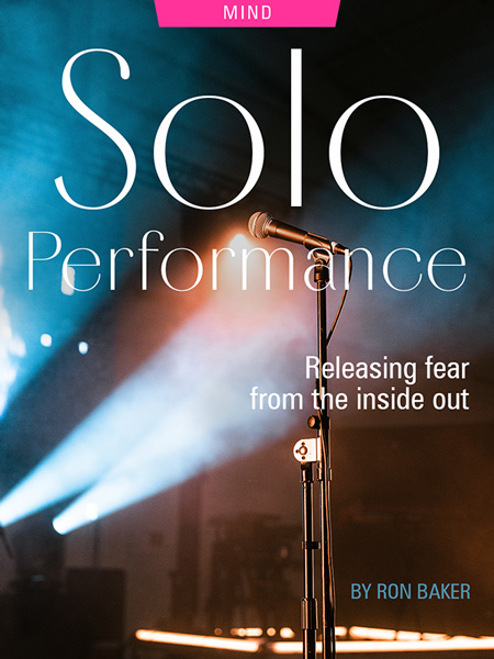 Solo Performance: Releasing Fear from the Inside Out, by Ron Baker. Photograph of microphone and stand atop empty stage, by Matthew Jungling.